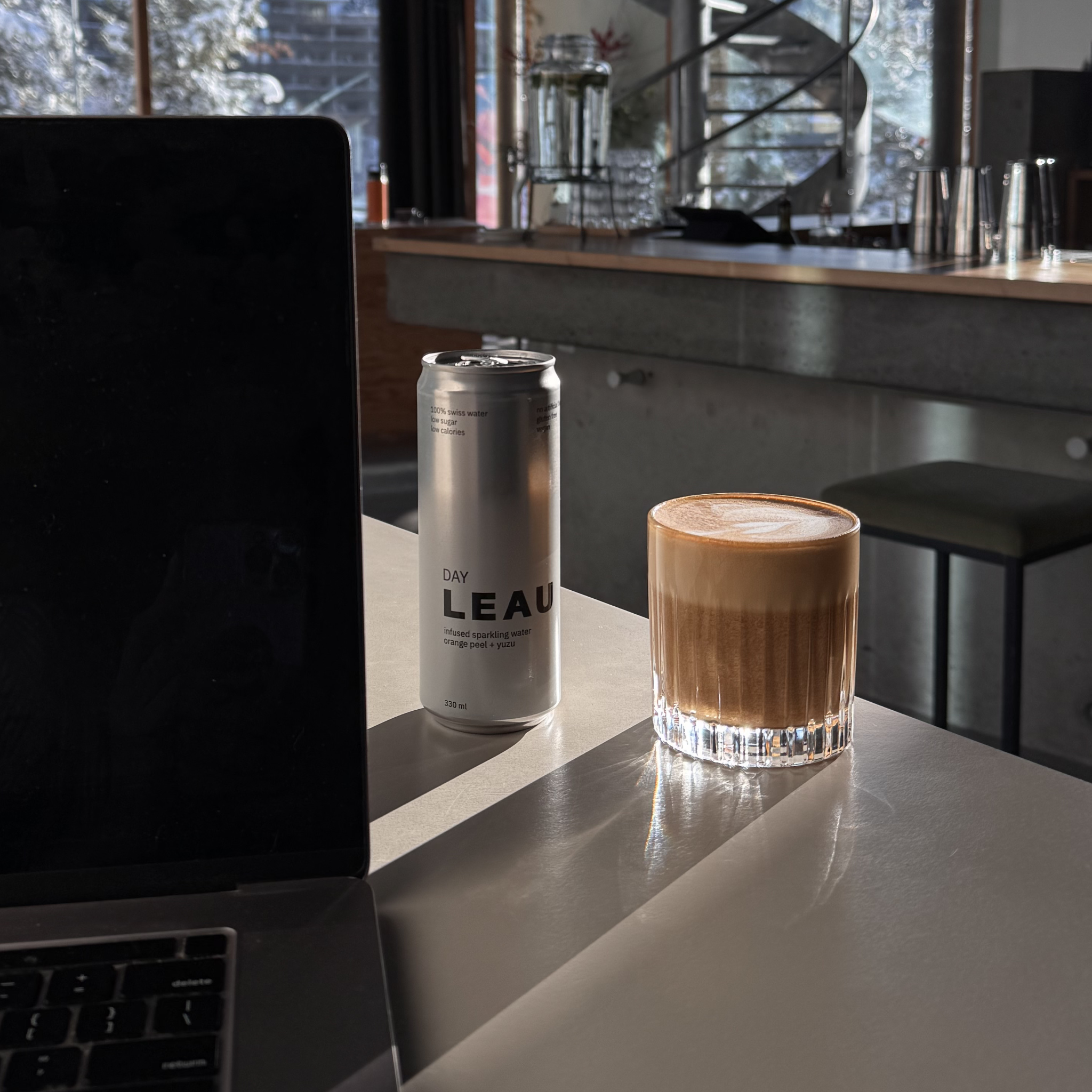 LEAU DAY can next to a coffee