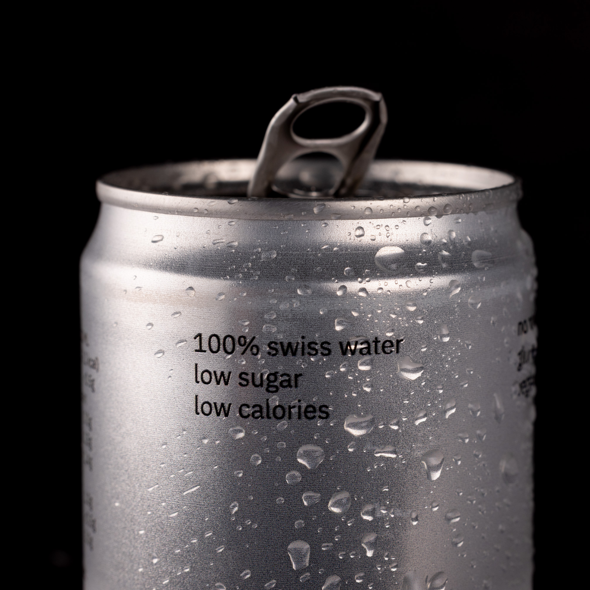 Silver can with water droplets and text on a black background